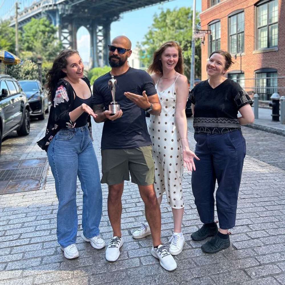 Synima New York team receiving an award