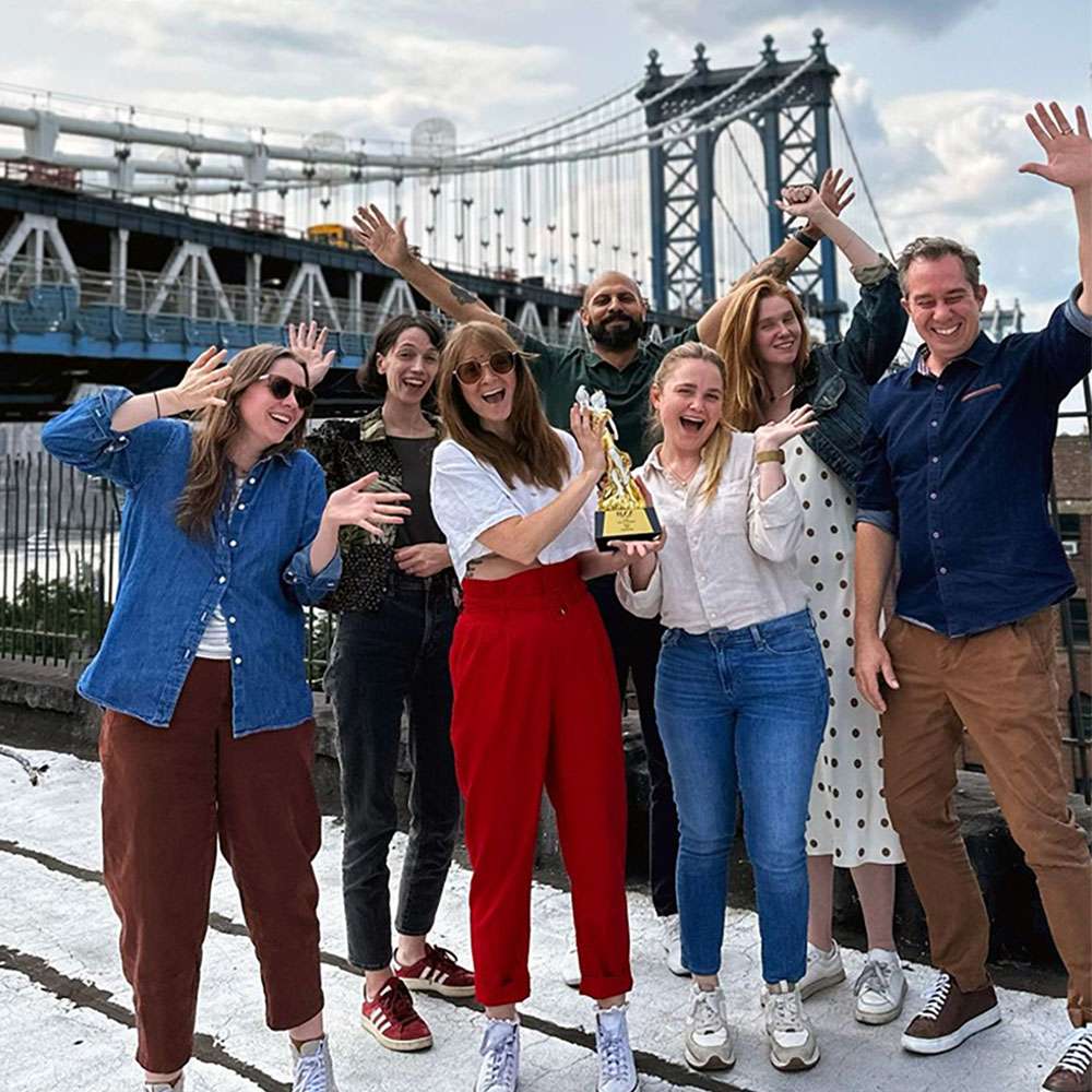 Synima New York team receiving an award