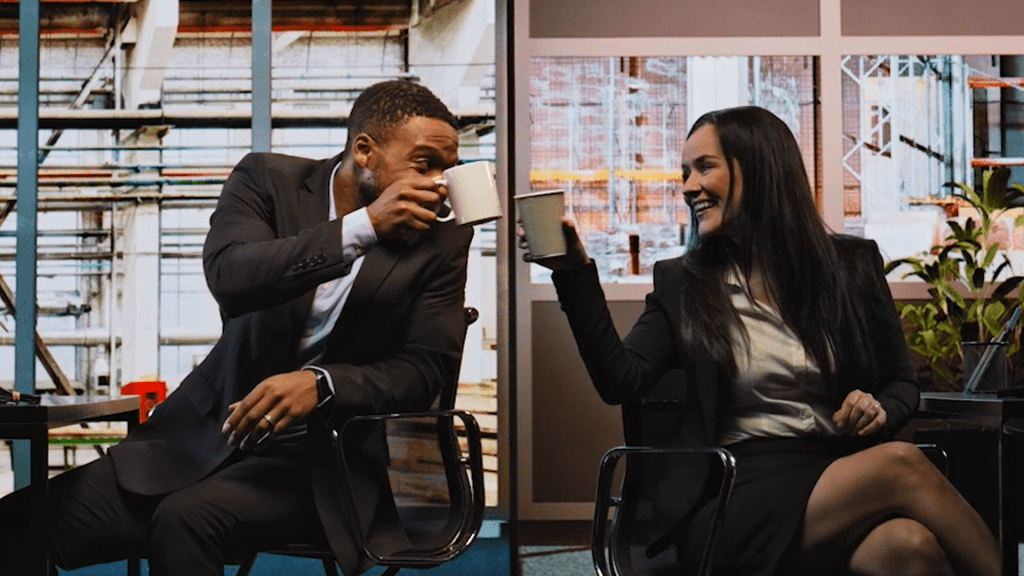 tech showreel thumb two employees drinking coffee and smiling at each other