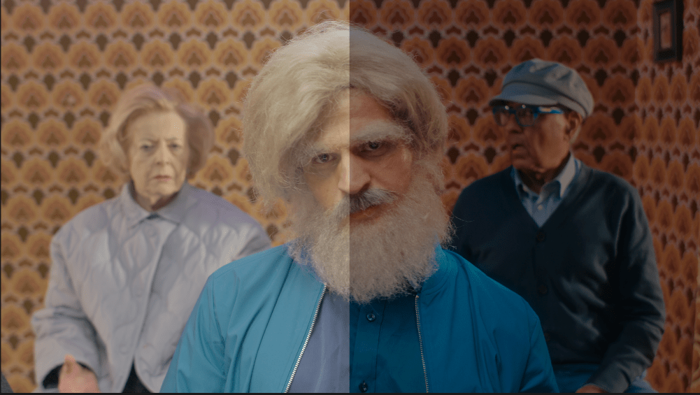 image showing the benefit of colour grading for video production image of a man on a video production set with a splitscreen showing the benefit of colour grading
