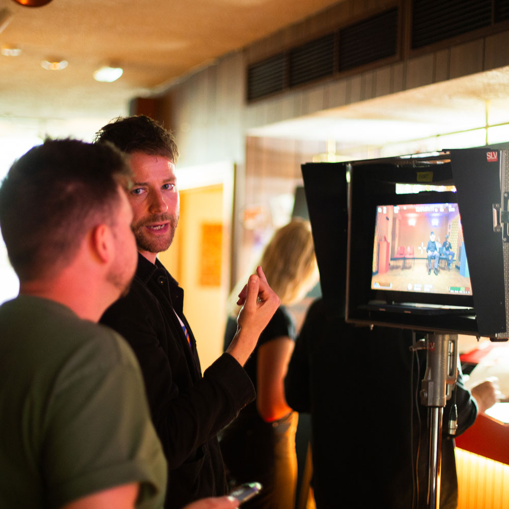 Synima director reviewing a shot on a camera monitor during a London video production